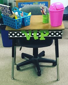 an office chair with polka dots on it and a wooden desk topped with two bins filled with pens and pencils