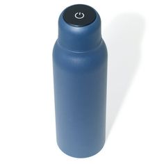 a blue water bottle sitting on top of a white table next to a black lid