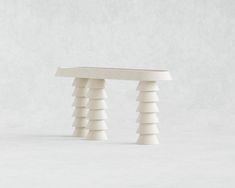 a white table sitting on top of a white floor