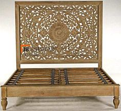 a wooden bed frame with intricate carvings on it