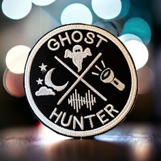 a black and white patch with the words ghost hunter on it