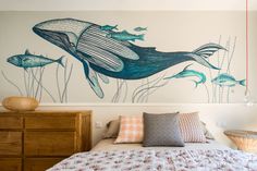 a bedroom with a whale mural on the wall