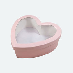 a pink heart shaped box sitting on top of a table