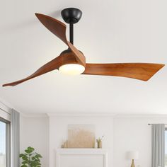 a living room with a ceiling fan in the middle of it's wooden blades