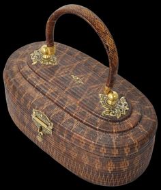 an old wooden box with gold handles on a black background