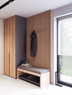 a wooden bench sitting in front of a window next to a coat rack and shoes