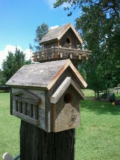 a bird house made out of wood on top of a tree stump