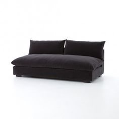 a black couch sitting on top of a white floor