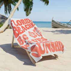 an orange and white beach towel sitting on top of a chair