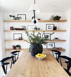 a wooden table topped with a bowl of fruit