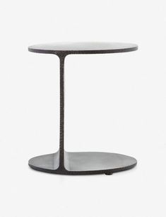 a black and white table with a circular base on it's side, against a white background