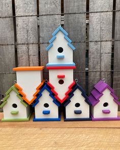 colorful bird houses are stacked on top of each other