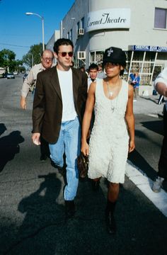 a man and woman walking down the street