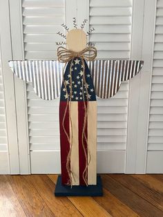 an american flag angel made out of wood