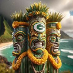 two green and yellow masks are standing next to each other near the ocean with mountains in the background