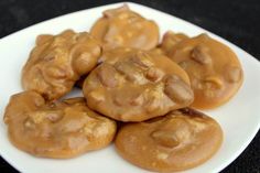 some cookies are on a white plate with caramel glaze