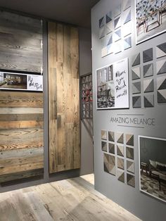 the interior of a building with wooden doors and pictures on the wall, along with wood flooring