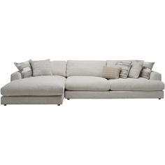 a large sectional couch with pillows on it's back and side facing the sofa