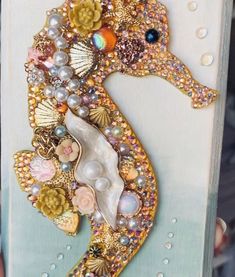 a sea horse with pearls and seashells on it's back