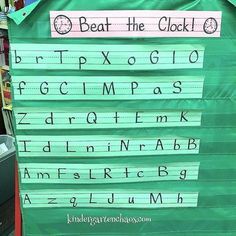 a green sign with writing on it that reads beat the clock and read the alphabet