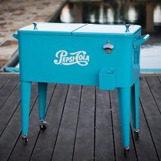 an ice chest sitting on top of a wooden dock