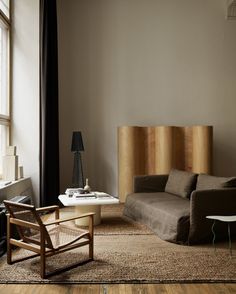 a living room filled with furniture next to a window