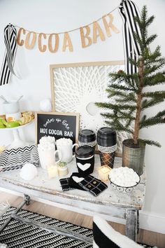 a table topped with lots of different types of drinks and desserts next to a sign that says cocoa bar