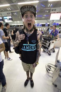 a man with his mouth wide open standing in an airport