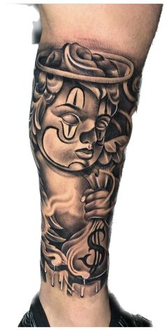 a man's leg with an artistic tattoo design on the side of his leg