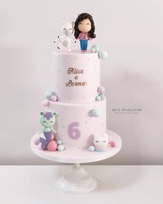 a three tiered cake with an animal figurine on top