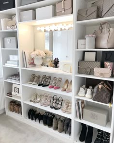 a white bookcase filled with lots of shoes and handbags on top of it