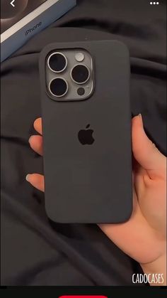 a person holding an iphone 11 in their hand with the case open and showing it's camera