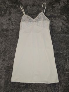 Light up your nights with this lovely form-fitting sleek feel nylon full slip from Lorraine. This is of 1960's style, with intricate lacework on the bust and bottom to bring out the flower in you! The official size on the tag is a women's size 36. Condition: Minor signs of wear. Fitted Delicate Lace Nightgown For Sleep, Fitted Sheer Lace Nightgown, Lace Fitted Slip For Sleep, Fitted Lace Nightgown With Built-in Bra, Fitted Lace Slip For Sleep, Fitted Lace Trim Camisole For Wedding Night, Fitted Nightgown With Lace Bodice For Sleep, Fitted Lace Bodice Nightgown For Sleep, Fitted Lace Bodice Nightgown