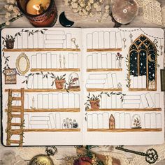 an open planner with lots of things on top of it and candles in the background