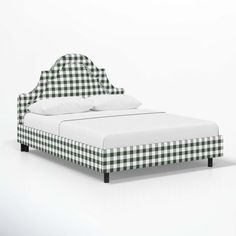 a bed with green and white checkered sheets on it's headboard is shown