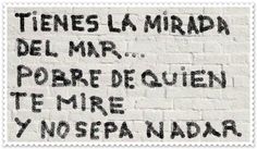 graffiti written on the side of a white brick wall in different languages, including english and spanish