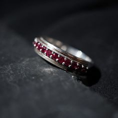 This stunning ruby ring is made in sterling silver with 15 natural blood red rubies. Look closely and you can see two lines of gold inlay in 22K solid gold. A one-of-a-kind ring made for the stylish man. Materials:- Sterling silver band- 15 2mm round natural rubies- 5.1mm bandwidth ** Tippy Taste Men's are made-to-order. Please allow 3-4 week turnaround time. ShippingDomestic: Free shippingInternational: Free shippingAll orders are insured, comes with tracking, and with signature requirement. Pa Fall Rings, Stylish Man, Blood Red, Ruby Ring, Natural Ruby, Sterling Silver Bands, 22k Gold, Stylish Men, Silver Band