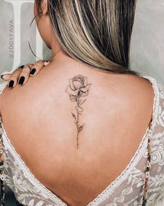 a woman with a rose tattoo on her back