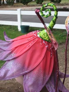 a close up of a child's head wearing a costume with flowers on it