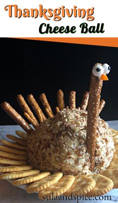 a turkey cheese ball with pretzels and crackers in the shape of an ostrich