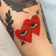 two heart shaped tattoos on the arm