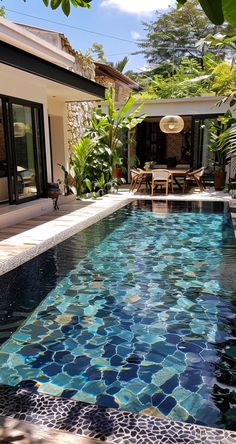 an outdoor swimming pool surrounded by greenery