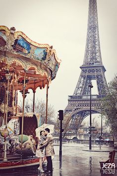 a couple kissing in front of the eiffel tower