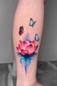 a woman's leg with watercolor tattoos and butterflies on it