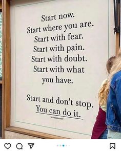 a woman standing in front of a sign that says start and don't stop you can do it