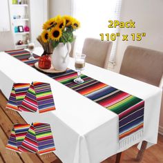 the table cloth is laid out on top of the dining room table with sunflowers