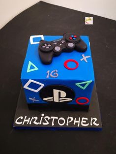 a blue cake with two video game controllers on it