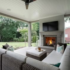 a living room with couches and a fire place in the middle of the room