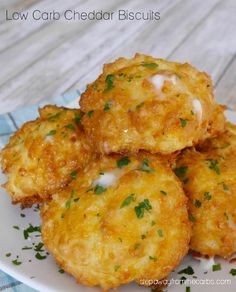 some fried food on a white plate with parmesan cheese and chives in the middle