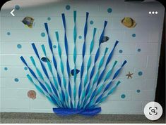 this is an image of a wall decoration with blue straws and sea animals on it